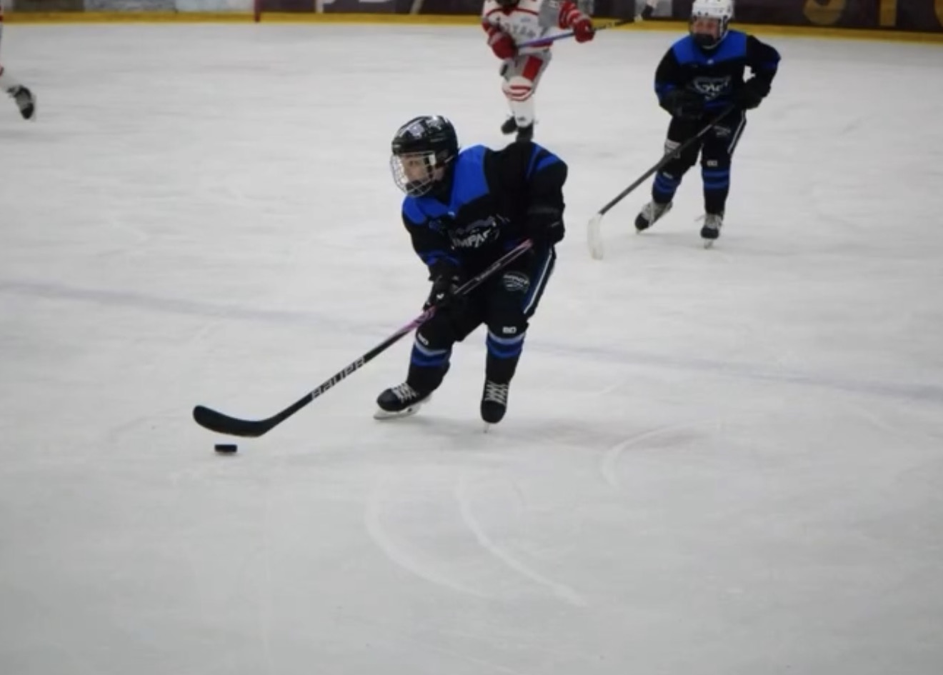Player carrying the puck up ice during tournament play