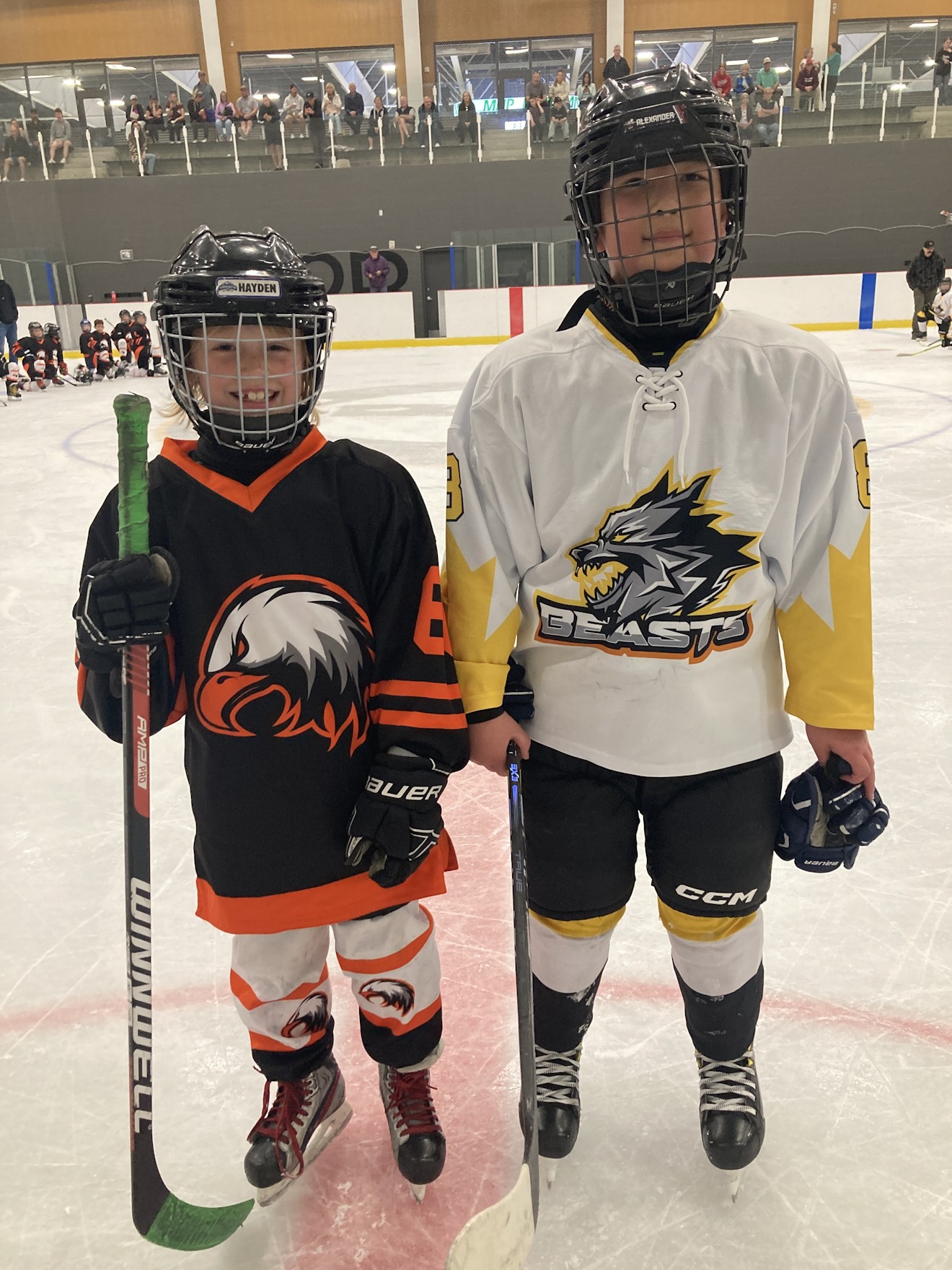 Two young Kozak Cup players on the ice before a game