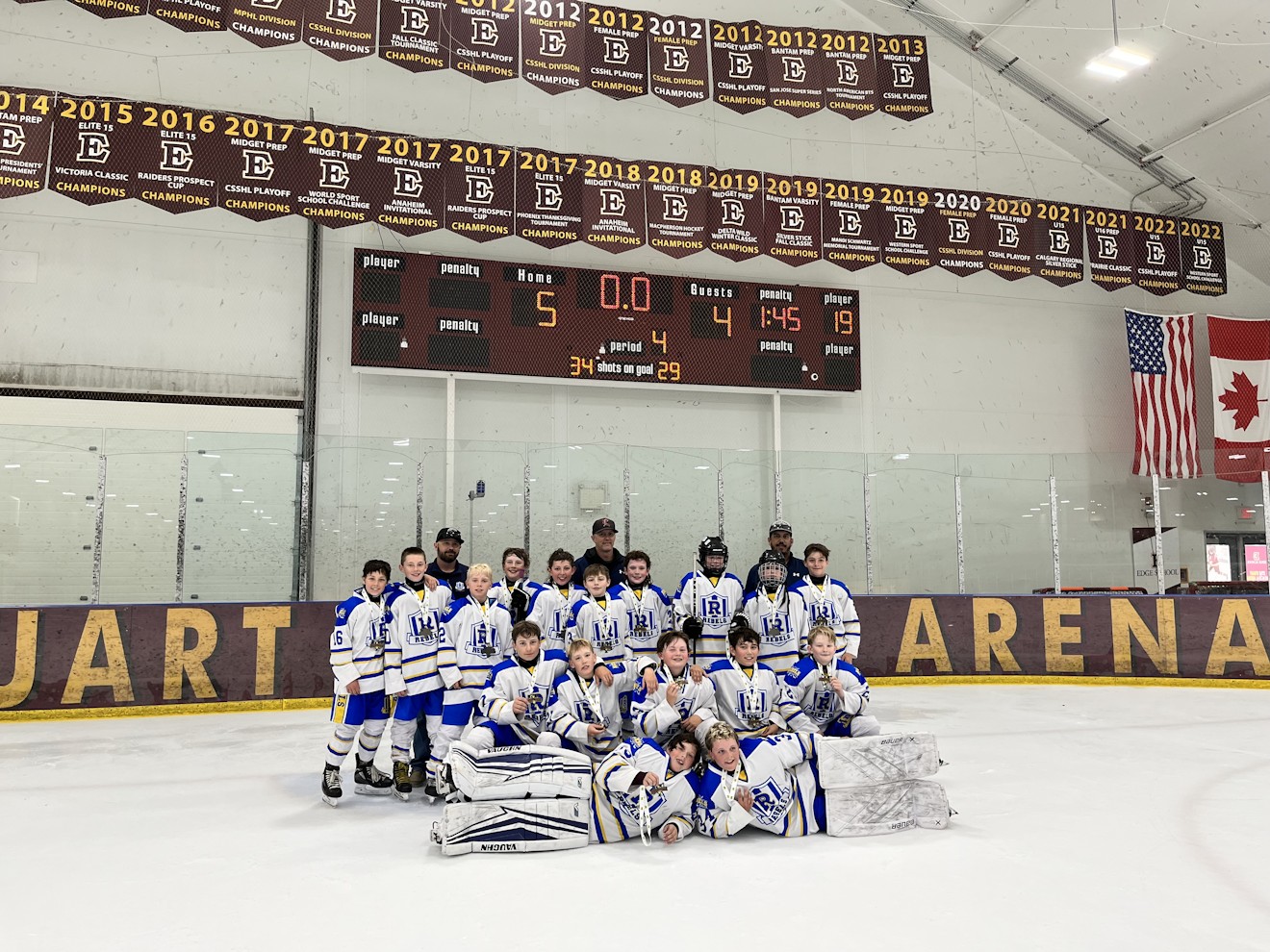 Kozak Cup champions team photo with medals at centre ice